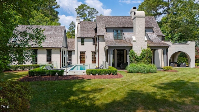 rear view of house with a lawn