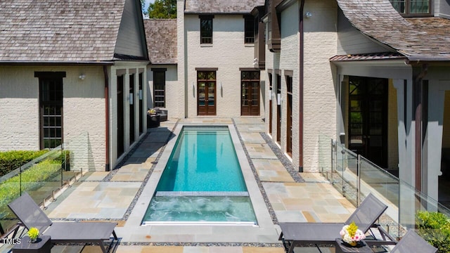 view of swimming pool with an in ground hot tub