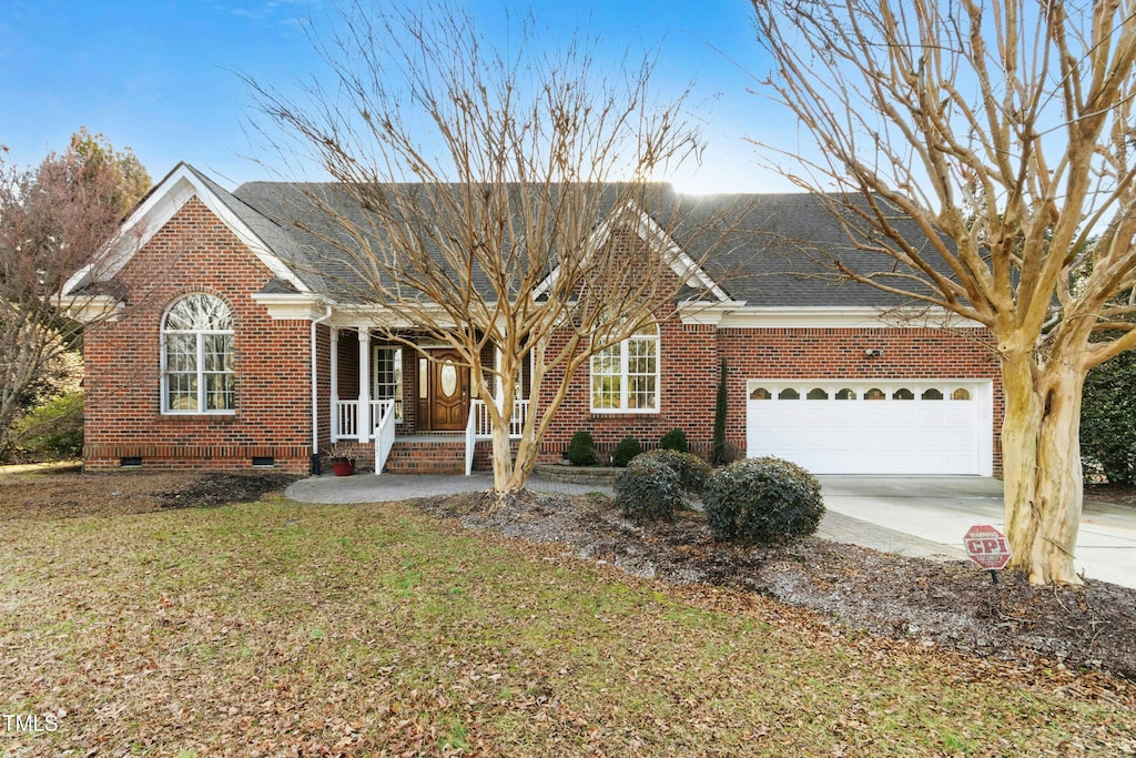 view of front of house with a garage and a front yard