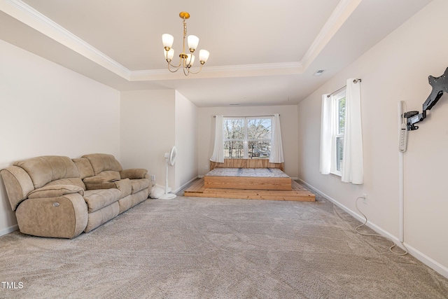 unfurnished living room featuring an inviting chandelier, a tray ceiling, carpet floors, and ornamental molding