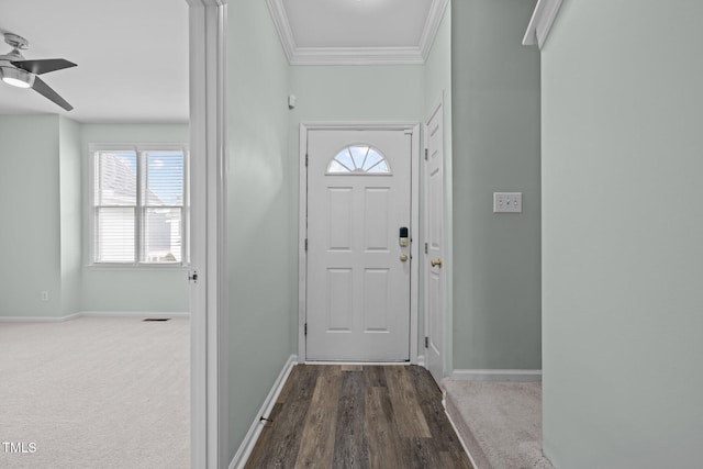 entryway with ornamental molding, carpet flooring, and ceiling fan