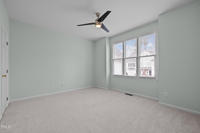 carpeted empty room featuring ceiling fan