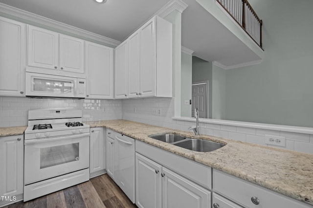 kitchen featuring sink, white appliances, white cabinetry, dark hardwood / wood-style floors, and decorative backsplash