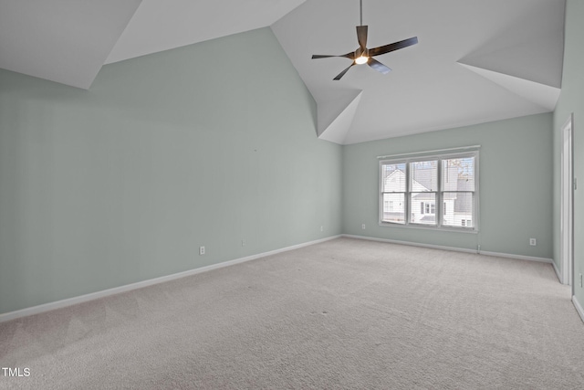 unfurnished room featuring ceiling fan, vaulted ceiling, and light carpet