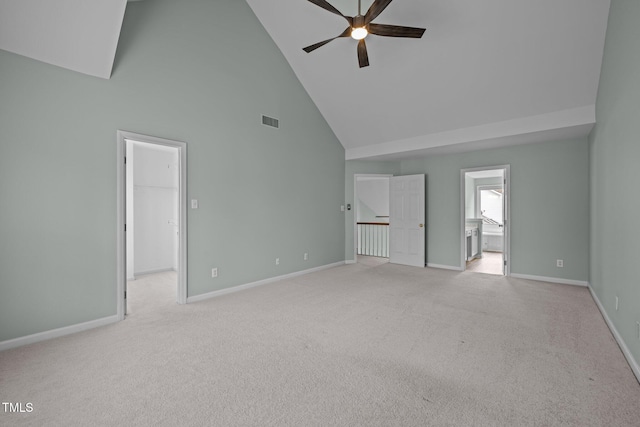 unfurnished living room with ceiling fan, light colored carpet, and high vaulted ceiling