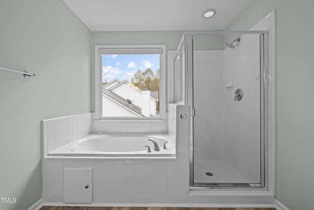 bathroom featuring separate shower and tub