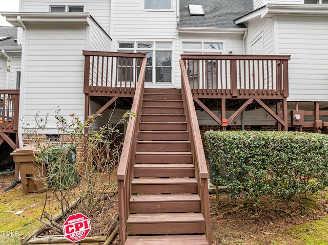 back of property featuring a wooden deck