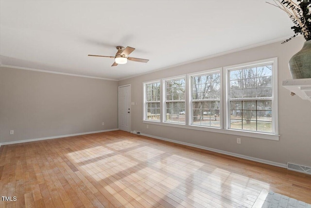 unfurnished room featuring light hardwood / wood-style flooring, ornamental molding, and ceiling fan