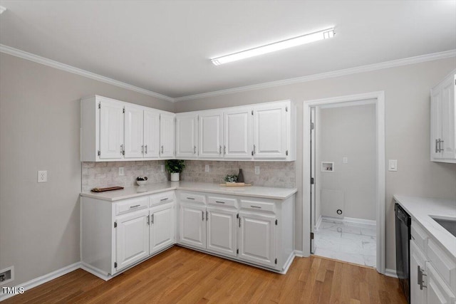 kitchen featuring ornamental molding, black dishwasher, light hardwood / wood-style floors, decorative backsplash, and white cabinets