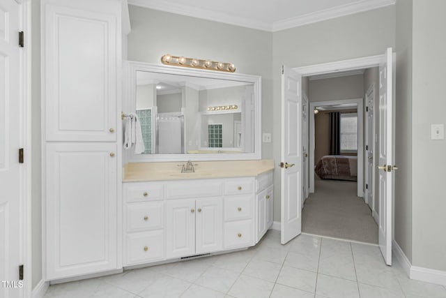 bathroom with crown molding, vanity, and tile patterned flooring