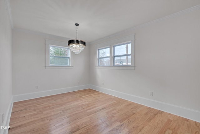 unfurnished room with a notable chandelier, ornamental molding, and light wood-type flooring