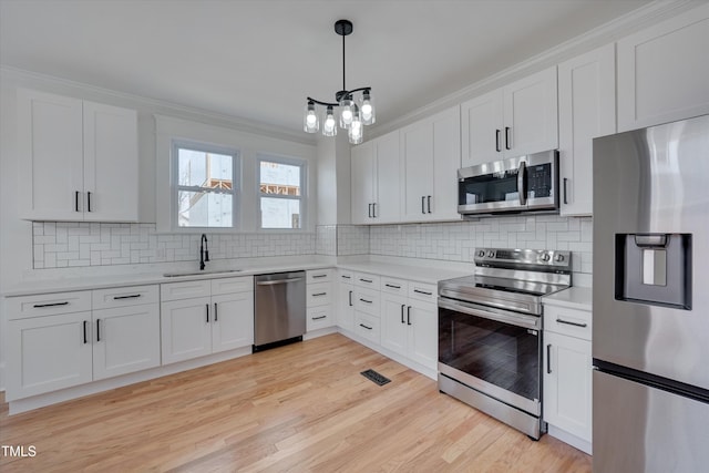 kitchen with white cabinetry, sink, and stainless steel appliances