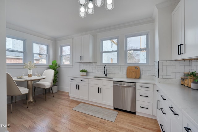 kitchen featuring sink, crown molding, light hardwood / wood-style flooring, stainless steel dishwasher, and white cabinets