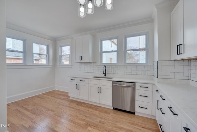 kitchen with sink, white cabinetry, light hardwood / wood-style flooring, stainless steel dishwasher, and ornamental molding