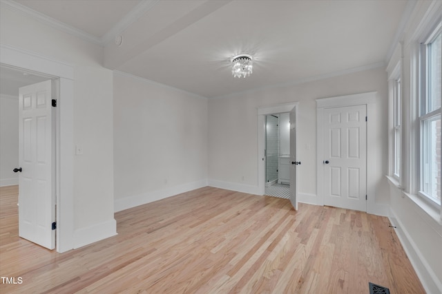 unfurnished room featuring crown molding and light wood-type flooring