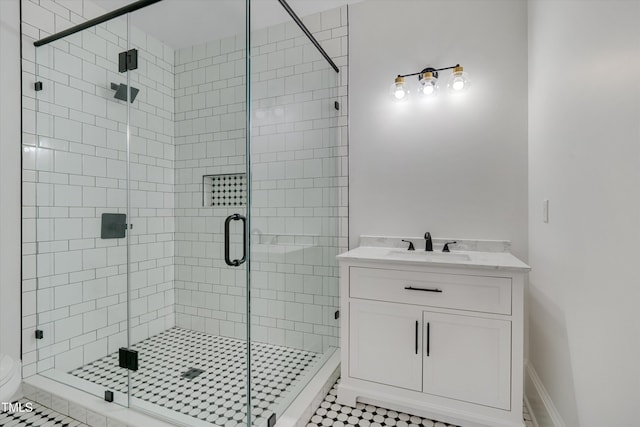 bathroom with vanity and a shower with shower door