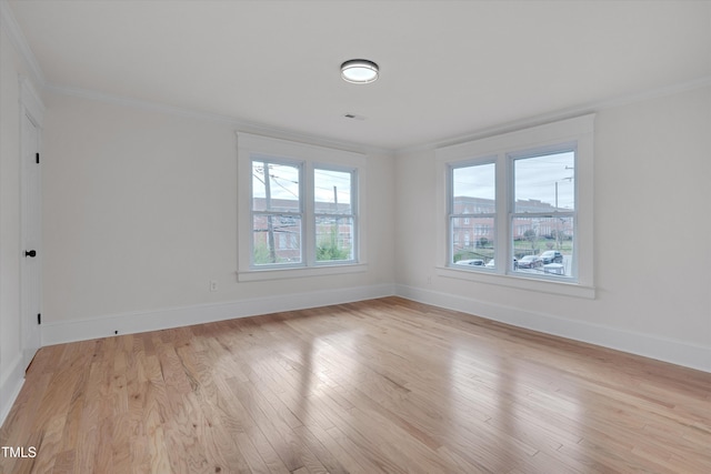 spare room with crown molding and light hardwood / wood-style flooring