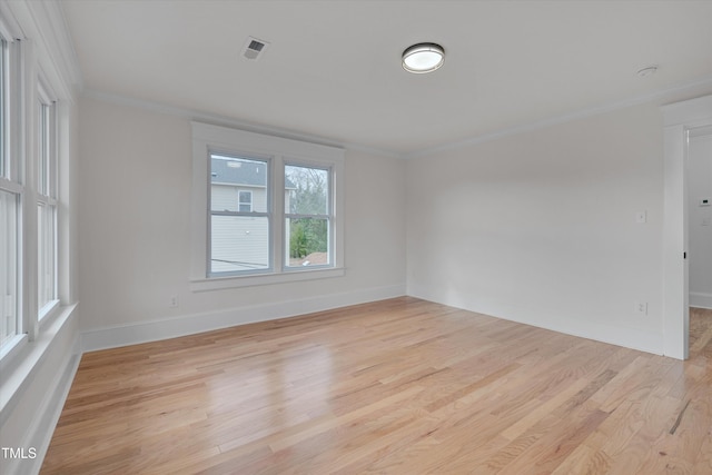 unfurnished room with ornamental molding and light hardwood / wood-style floors