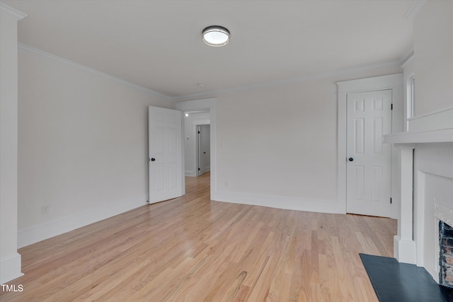 unfurnished living room with ornamental molding and light hardwood / wood-style flooring