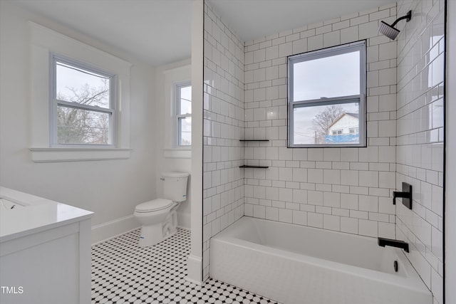 full bathroom with tile patterned floors, vanity, toilet, and tiled shower / bath combo