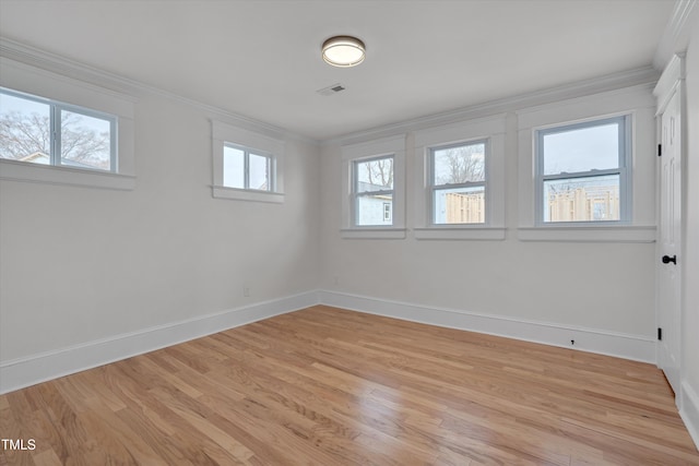 unfurnished room with ornamental molding and light hardwood / wood-style floors