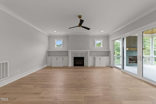 unfurnished living room with ornamental molding, ceiling fan, and light wood-type flooring