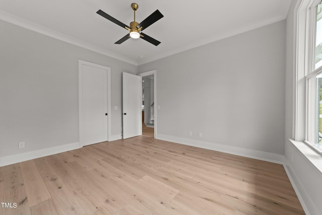 spare room featuring crown molding, ceiling fan, and light hardwood / wood-style floors