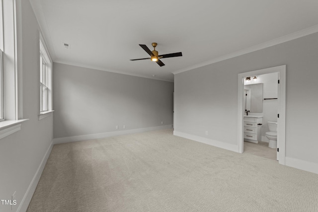 unfurnished bedroom featuring ensuite bathroom, ornamental molding, light carpet, and ceiling fan