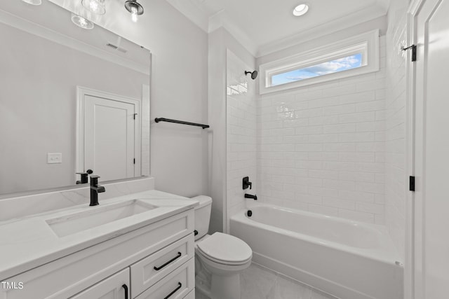 full bathroom featuring tiled shower / bath, vanity, toilet, crown molding, and tile patterned floors