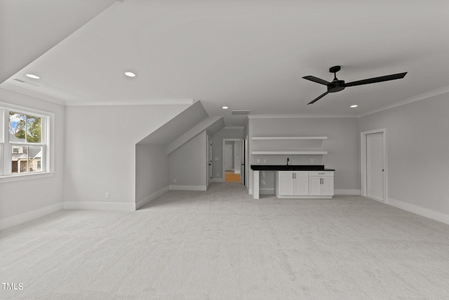 additional living space featuring ceiling fan and light carpet