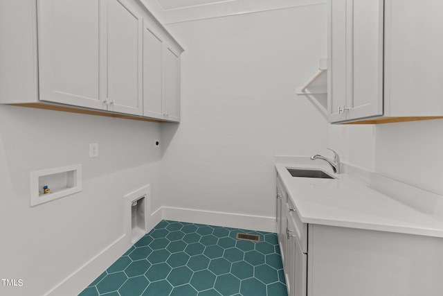 laundry area with sink, hookup for a washing machine, cabinets, tile patterned floors, and hookup for an electric dryer