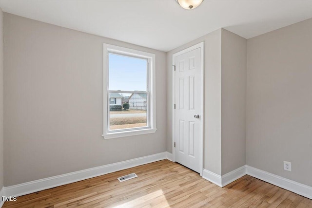 spare room with light hardwood / wood-style floors