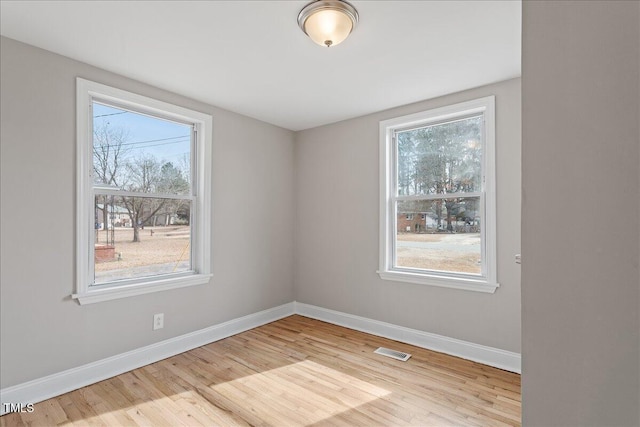 empty room with light hardwood / wood-style flooring