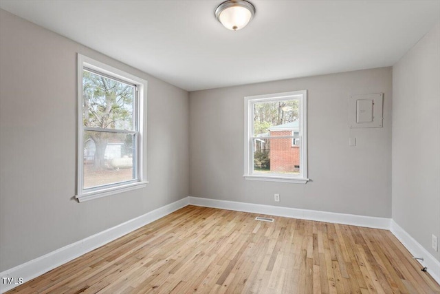 spare room featuring light hardwood / wood-style flooring