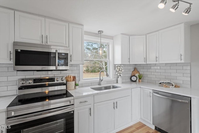 kitchen featuring white cabinetry, appliances with stainless steel finishes, and sink