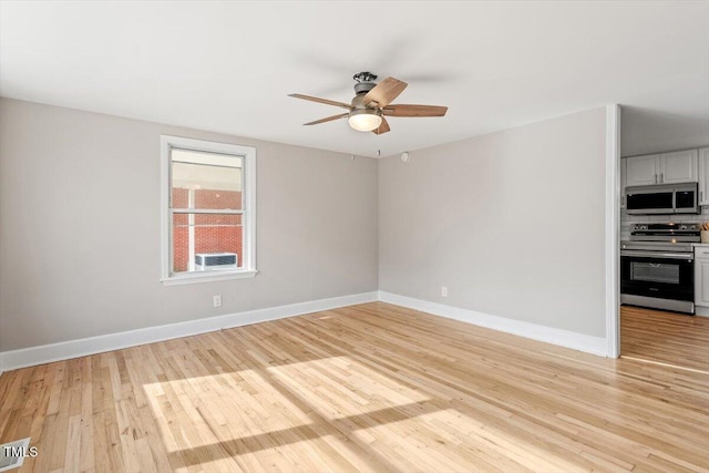 empty room with light hardwood / wood-style floors and ceiling fan