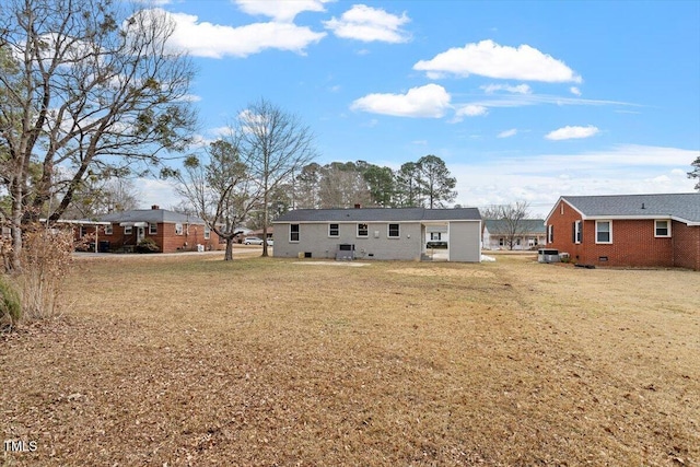 rear view of house with a yard and central air condition unit