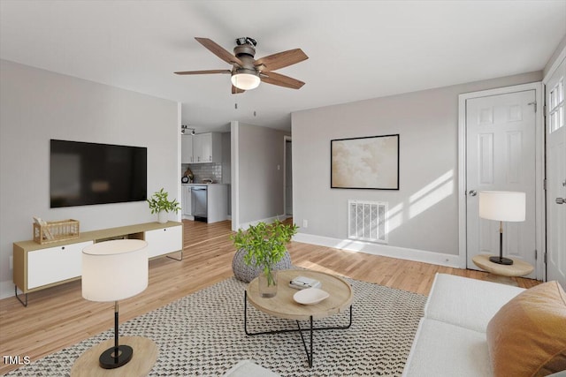 living room featuring ceiling fan and light wood-type flooring