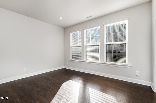 spare room featuring dark hardwood / wood-style floors