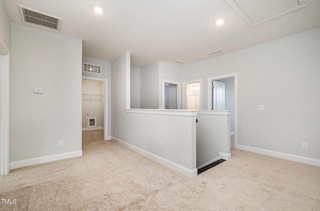 spare room featuring light colored carpet