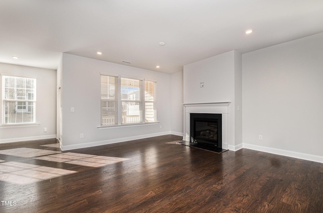 unfurnished living room featuring dark hardwood / wood-style flooring