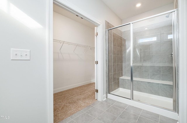 bathroom featuring an enclosed shower and tile patterned floors