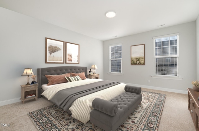 carpeted bedroom featuring multiple windows