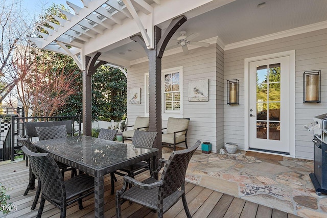 wooden deck featuring ceiling fan and a pergola