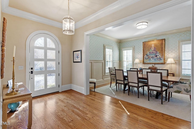 entryway featuring a notable chandelier, ornamental molding, hardwood / wood-style floors, and a wealth of natural light