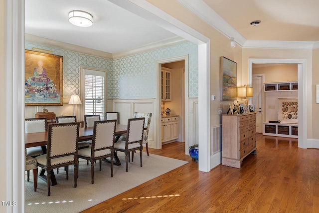 dining area featuring ornamental molding and hardwood / wood-style floors