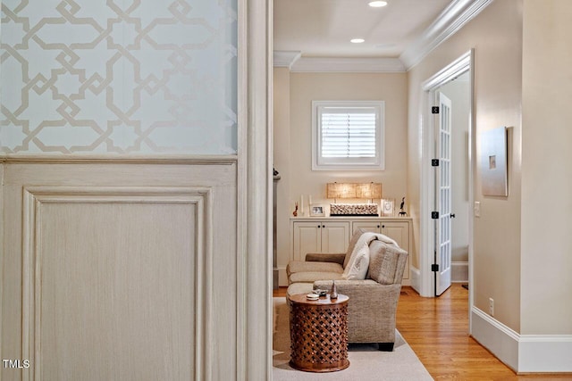 interior space featuring ornamental molding and light hardwood / wood-style floors