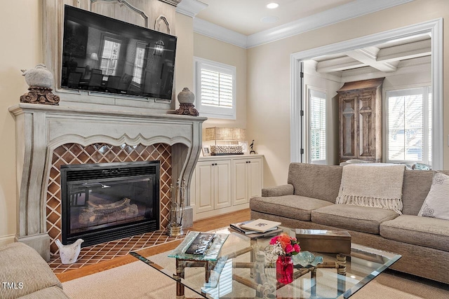 living room with coffered ceiling, beam ceiling, light wood-type flooring, ornamental molding, and a fireplace