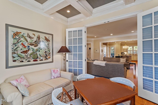 living room with coffered ceiling, beam ceiling, ornamental molding, and french doors