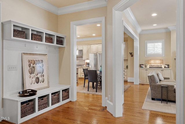 mudroom with crown molding and light hardwood / wood-style flooring